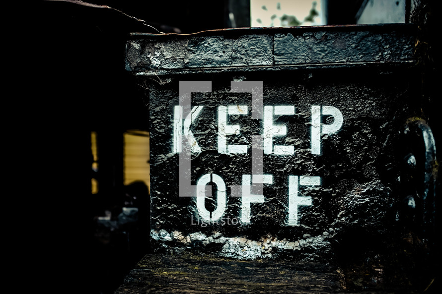 "Keep Off" sign in an outside alley.