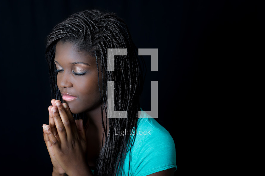 teen girl in reverent prayer