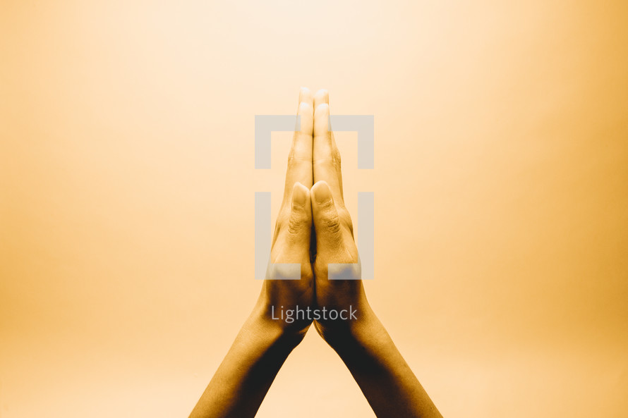 raised praying hands 