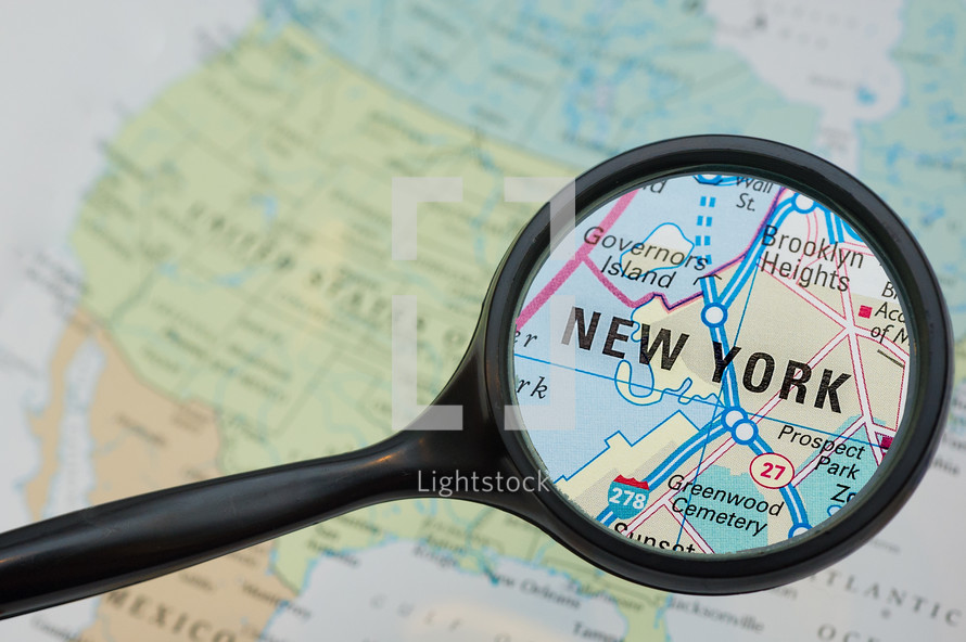 magnifying glass over New York on a map 