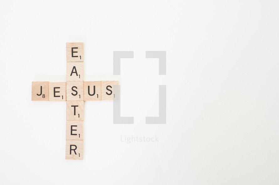Cross of scrabble pieces forming the words Jesus and Easter