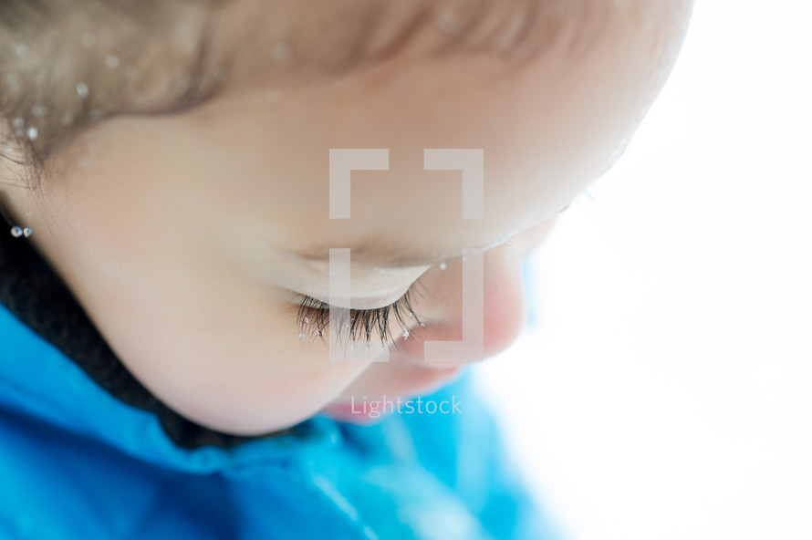 snow in a child's hair and eyelashes