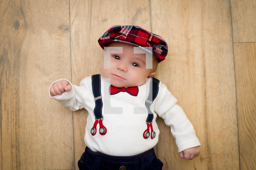 infant boy in suspenders 