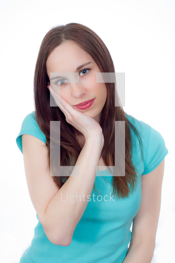woman with her hand resting on her face