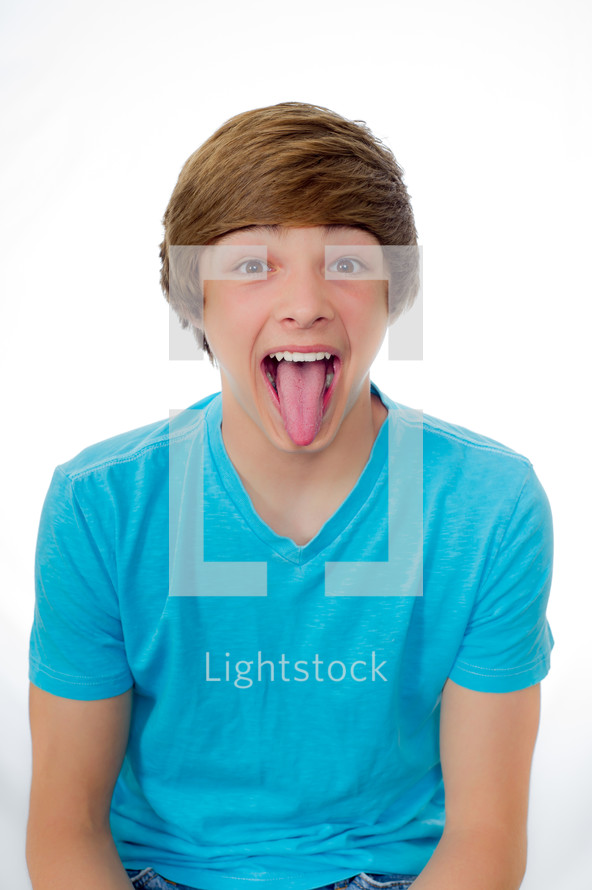 teen boy sticking his tongue out