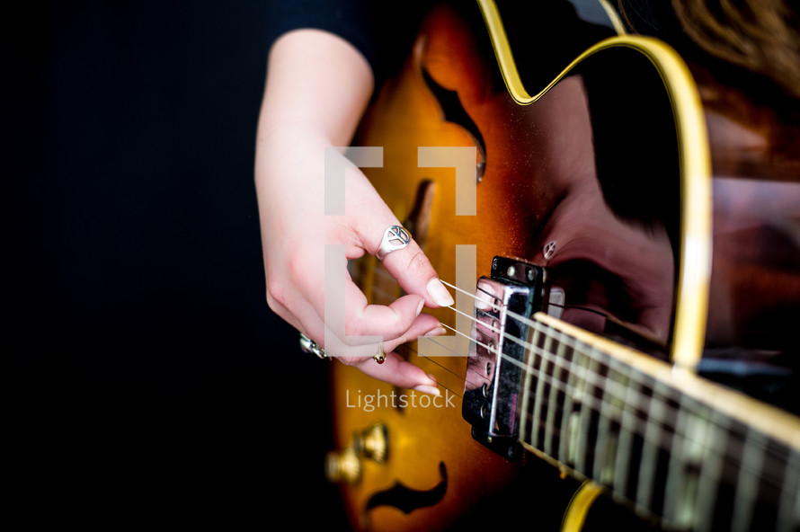 woman playing a guitar