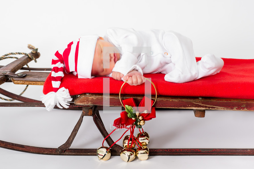 baby on a Christmas sleigh