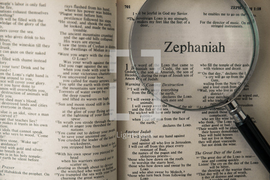 magnifying glass over Bible - Zephaniah 