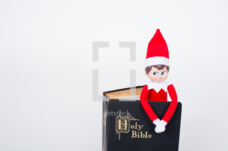elf on a shelf in a Bible 