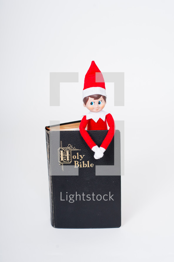 elf on a shelf in a Bible 