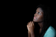 A teen girl in reverent prayer