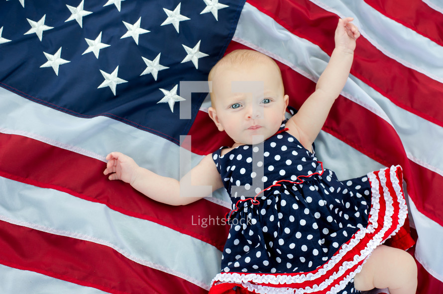 infant girl on an American flag 