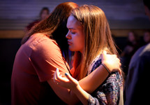 girls hugging at a worship service 