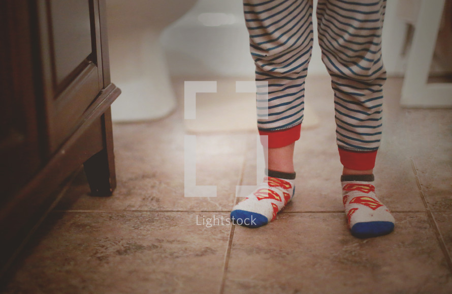 feet of a little boy in socks and pajamas 