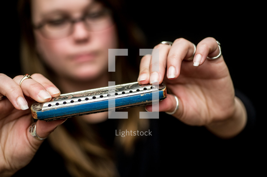 woman holding a harmonica