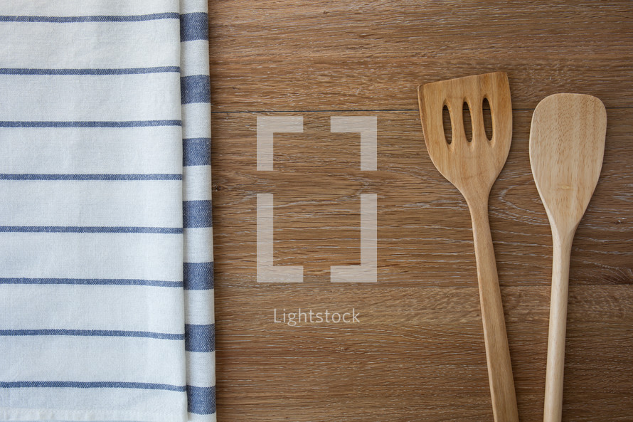 wooden spoons and towels on wood 