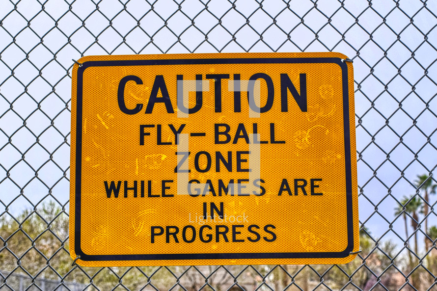 caution fly-ball zone while games are in progress sign 