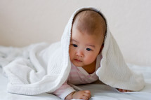 an infant under a blanket 