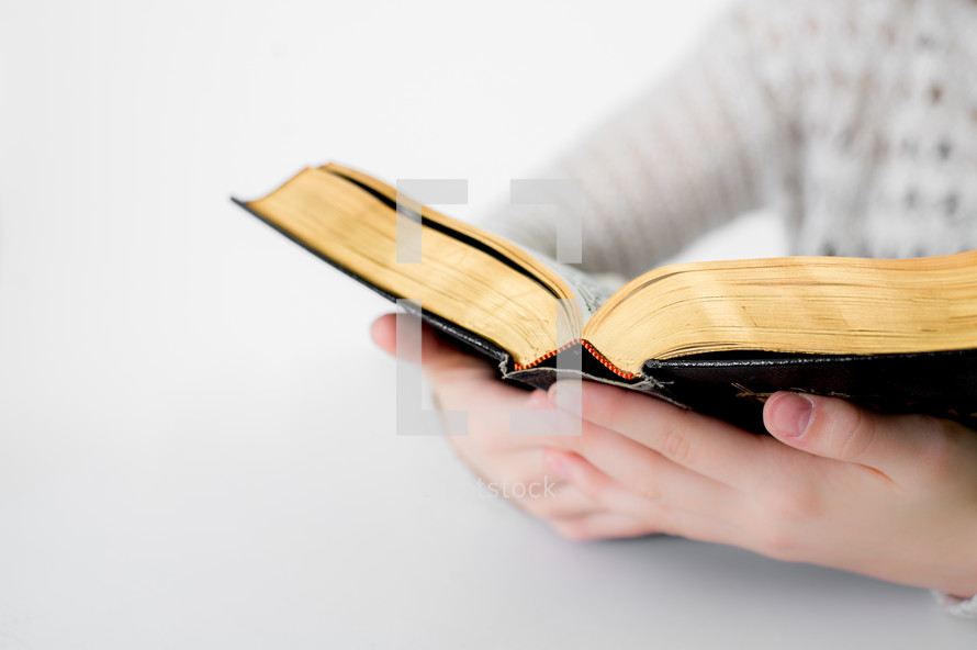 A teen girl reading a Bible 