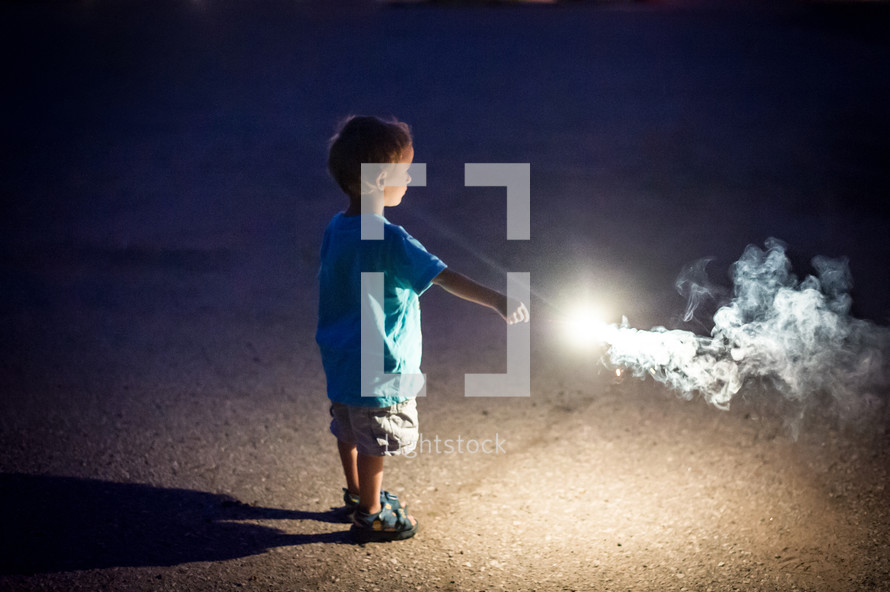 toddler boy holding a sparkler 