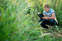 man reading the Santa Biblica in the wilderness 