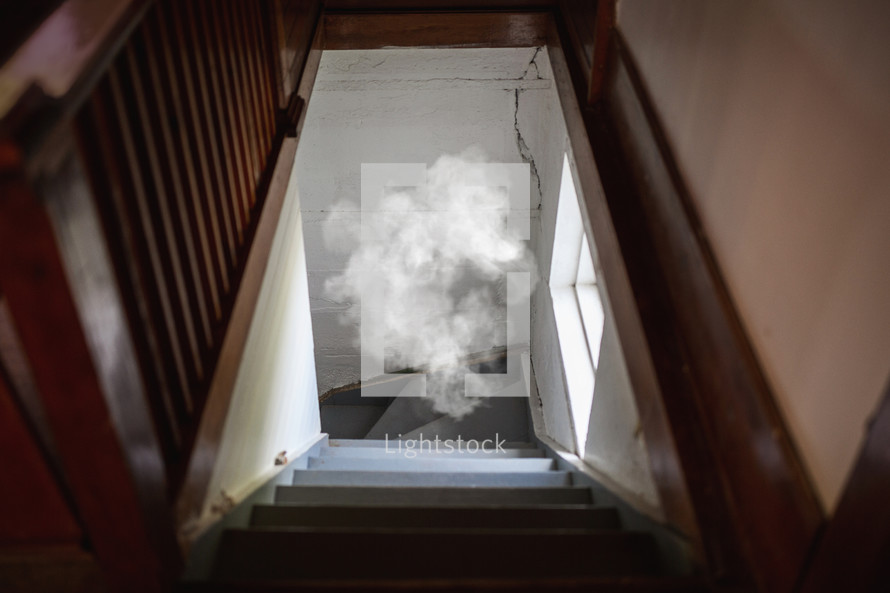 cloud hovering in stairwell of church basement