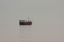 a replica fishing boat on the sea of Galilee