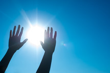 raised hands and a sunburst 