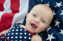 infant girl on an American flag