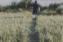 a man walking on a worn path 