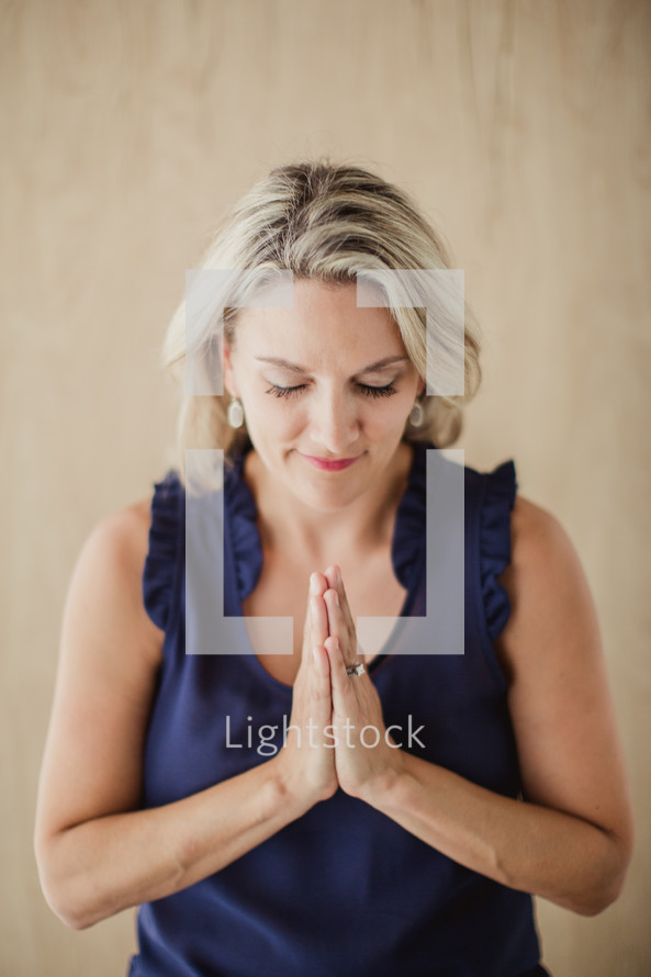 woman with head bowed in prayer 