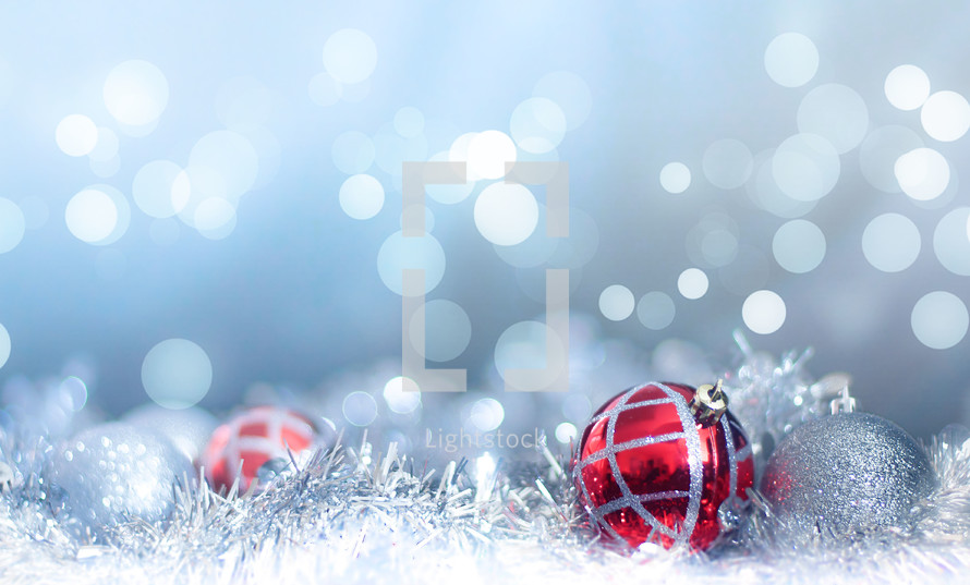 Red and silver Christmas decorations with blue bokeh background