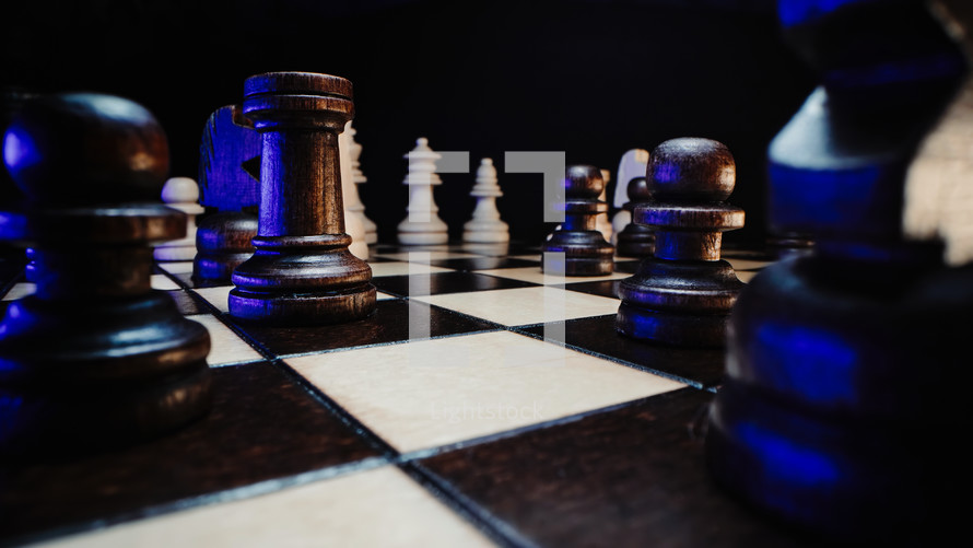  macro shot, chess pieces on wooden chessboard before party competition. Board strategy game. Teamwork, success business, intelligence sport concept.