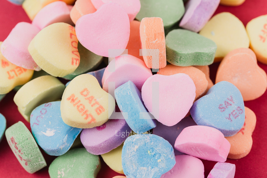 Multi-colored candy hearts with Valentine messages.