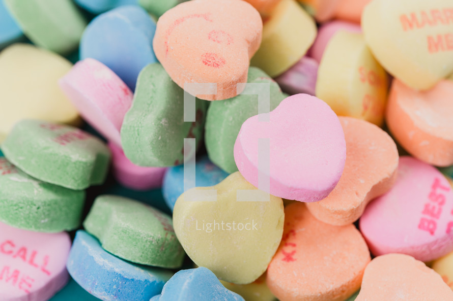 Multi-colored candy hearts with Valentine messages.