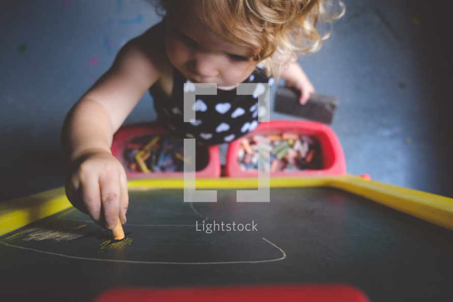 toddler playing with chalk 