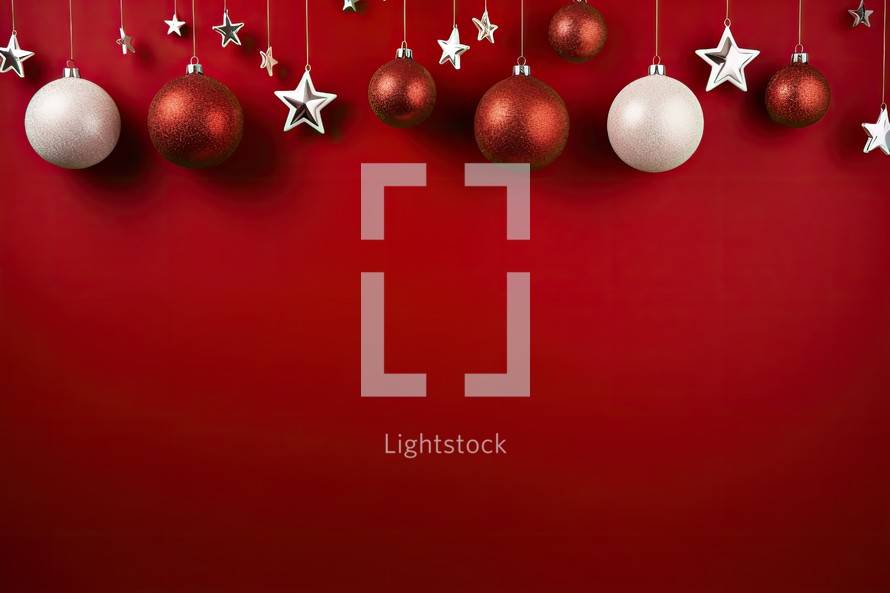 Christmas background with baubles and stars on a red background.