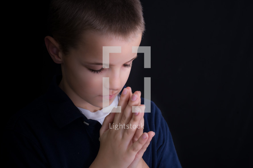 A boy child in prayer 