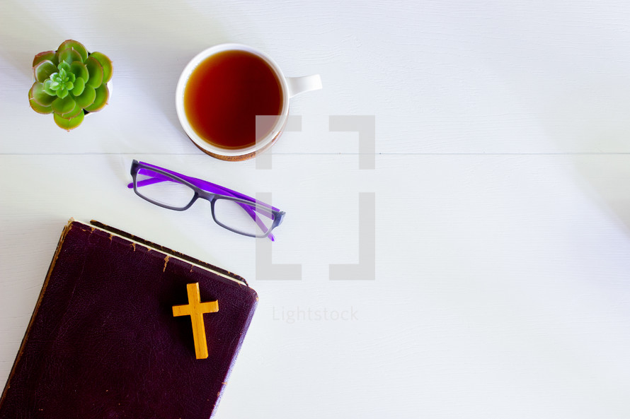 reading glasses, Bible, and cross 