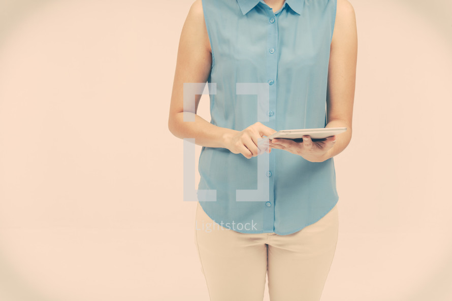 a woman with her finger on a tablet screen 