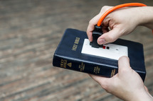 power of scripture - Bible with an outlet and power cord plugged in