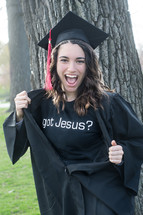 Smiling graduate wearing "Got Jesus" t-shirt under her cap and gown.