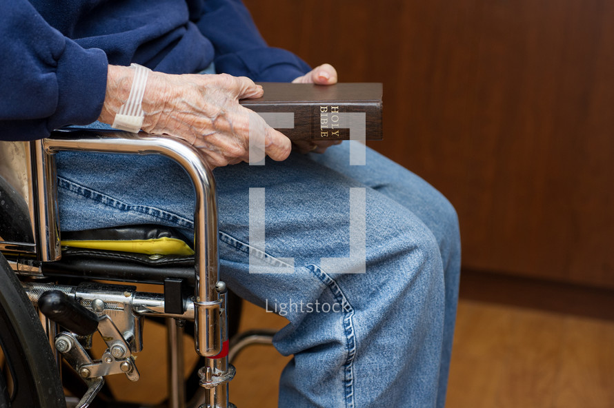elderly woman holding a Bible 