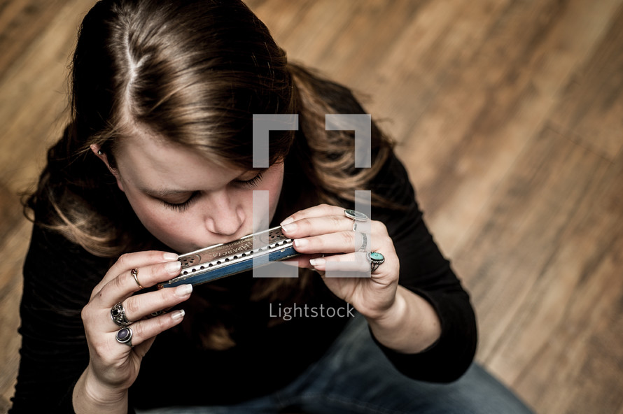 woman playing a harmonica