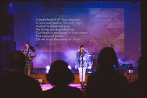 songs on a projection screen during a worship service 