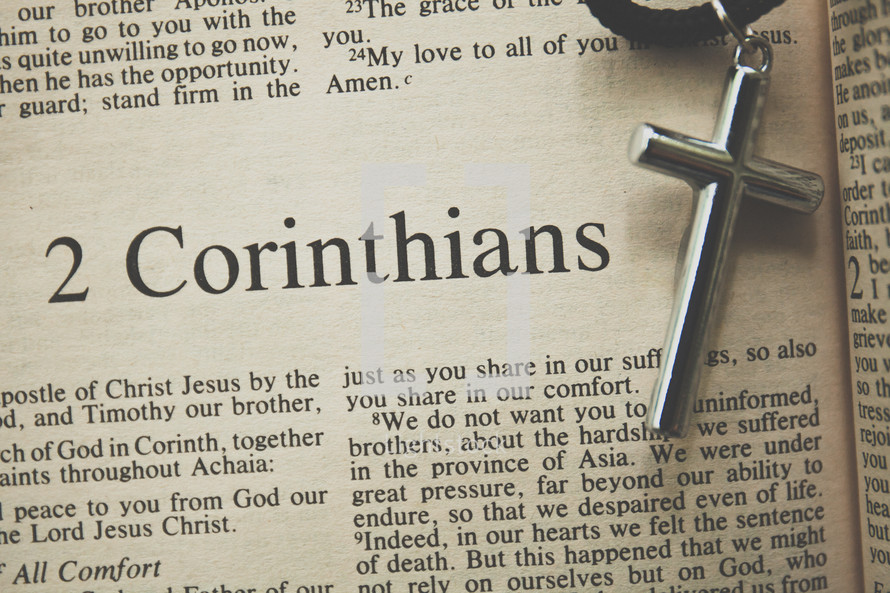 2 Corinthians and a cross necklace  