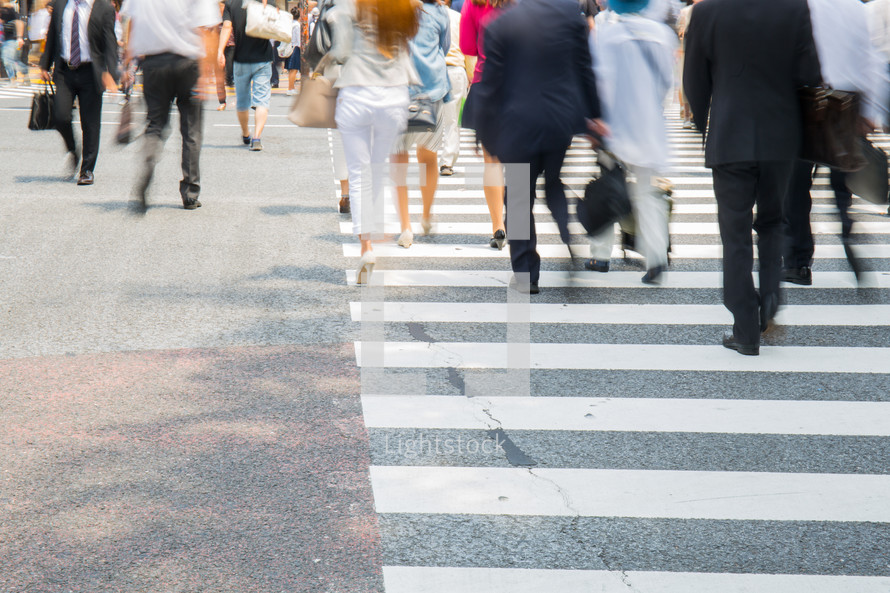 blur of people crossing a crosswalk 