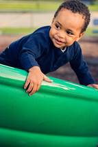 Boy on a playground slide.