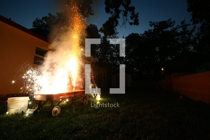 fireworks exploding in a red wagon