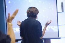 hands raised during a worship service 